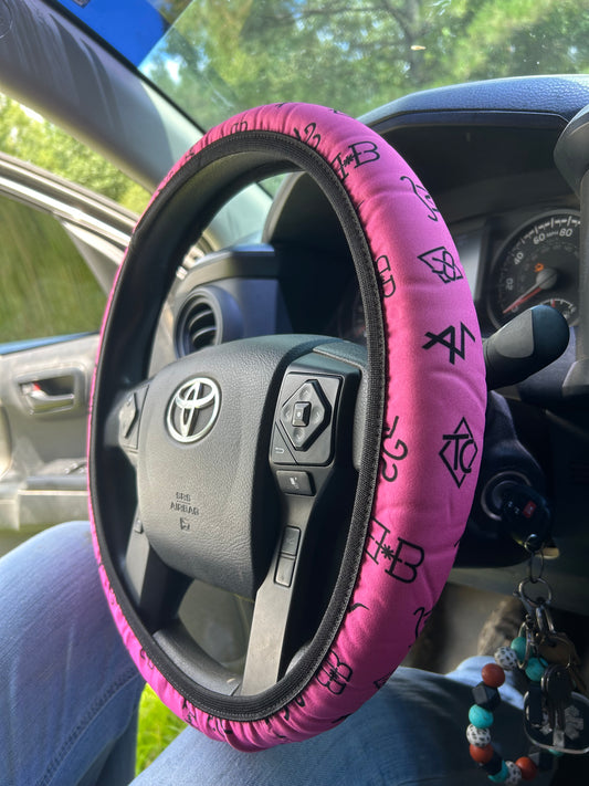 Pink cattle brand steering wheel cover